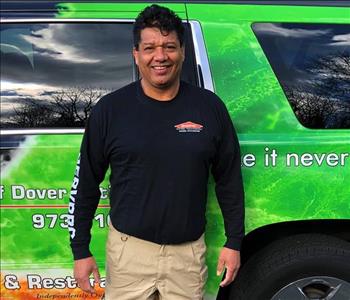 male posing in black servpro shirt in front of a truck