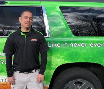 male posing in black servpro shirt in front of a truck