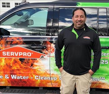 male posing in black servpro shirt in front of a truck