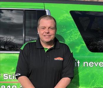 male posing in black servpro shirt in front of a truck