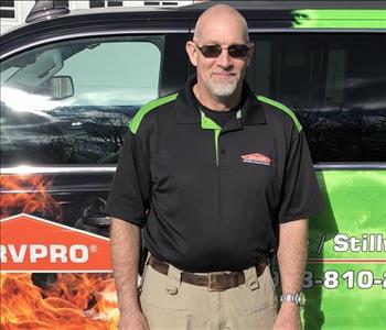 male posing in black servpro shirt in front of a truck