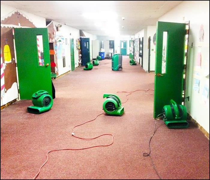 school hallway with air movers on the floor
