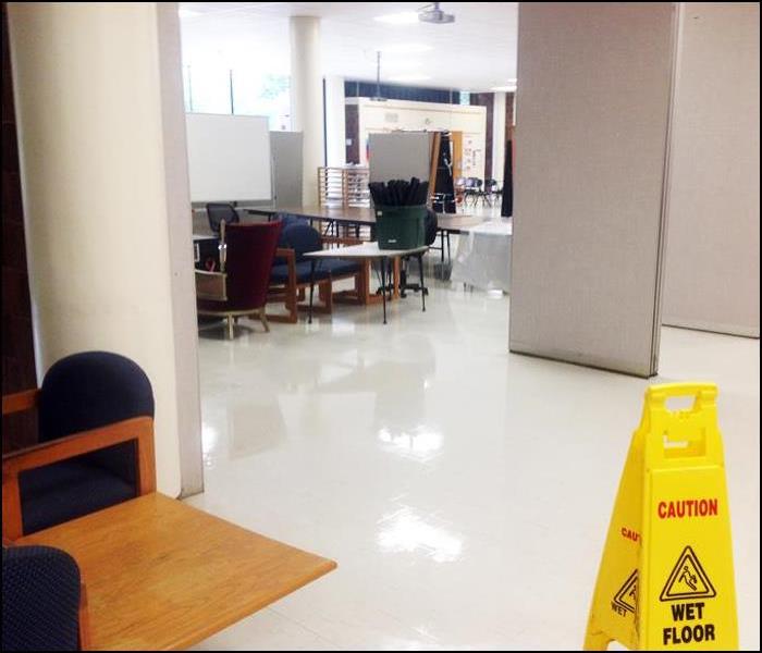 schools white tile flooring with water damage