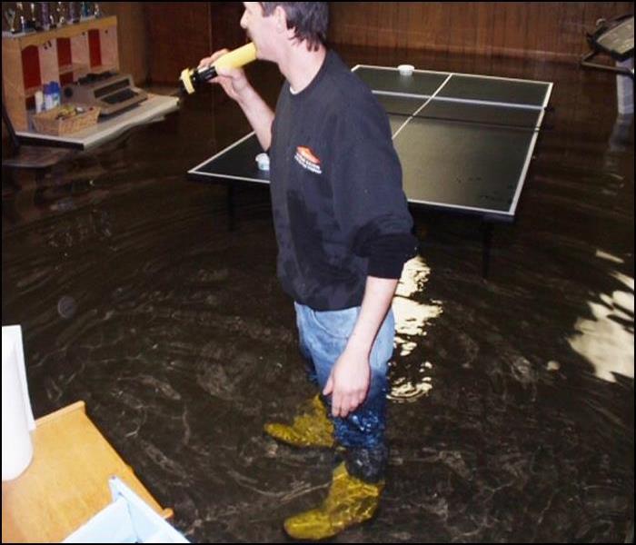 employee standing in a flooded basement